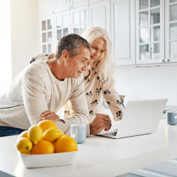Retirement Couple Planning their Finances in Kitchen